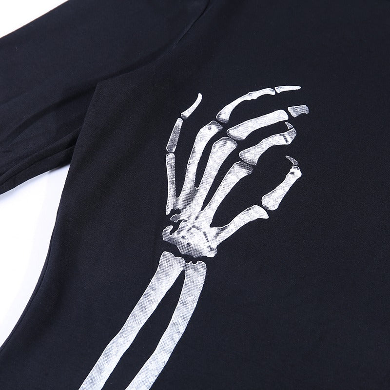 Close-up of skull print on black bodycon dress featuring a skeleton hand design, perfect for gothic streetwear.