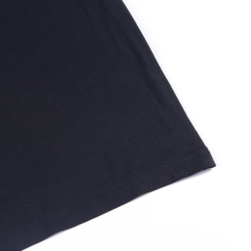 Close-up of the hem of a black bodycon long sleeve dress, showcasing the sleek fabric and design.