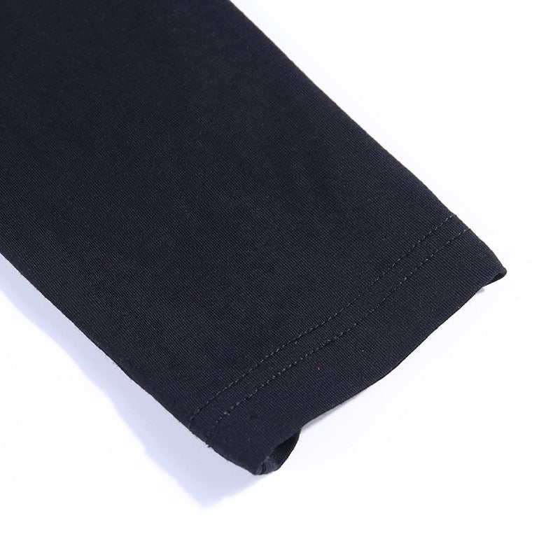 Close-up of the sleeve hem of a black bodycon long sleeve dress, showcasing smooth fabric and clean stitching details.