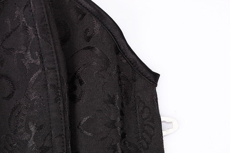 Close-up of a black Gothic corset fabric with intricate lace pattern and adjustable belly closure for women.