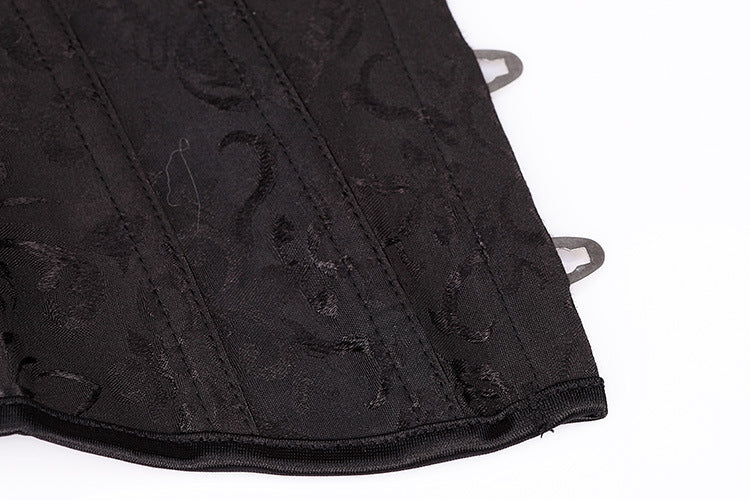 Close-up of black gothic corset with intricate lace design and belly closure, perfect for stylish women's underwear.