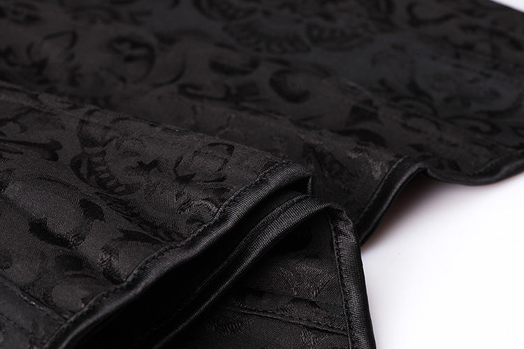 Close-up of black textured fabric featuring intricate gothic designs, perfect for a stylish corset top.