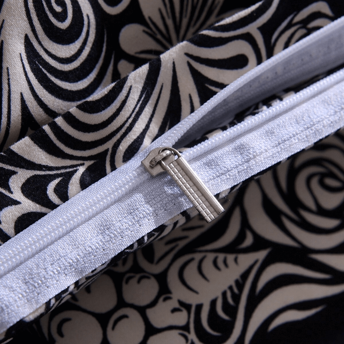 Close-up of a zippered black duvet cover featuring an intricate floral design for gothic home decor.