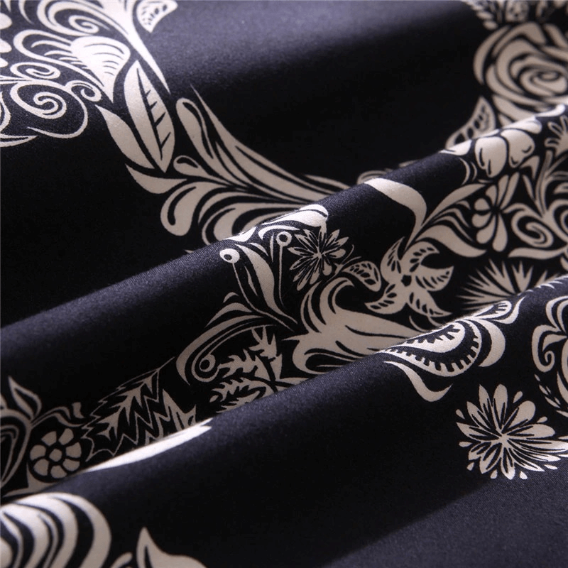Luxury black duvet cover fabric featuring intricate white floral and skull patterns, perfect for gothic home decor.