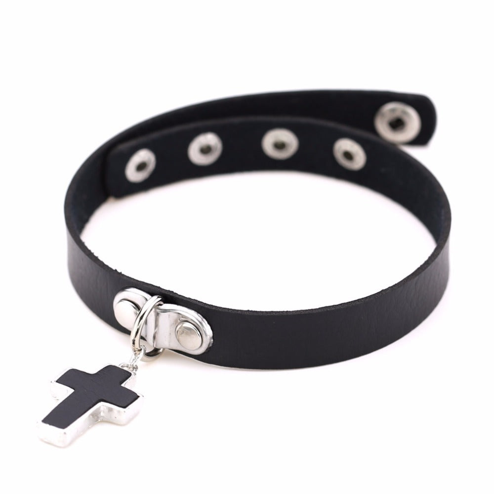 Stylish black leather gothic choker with cross charm and zinc rivets, perfect for rock concerts and edgy outfits.
