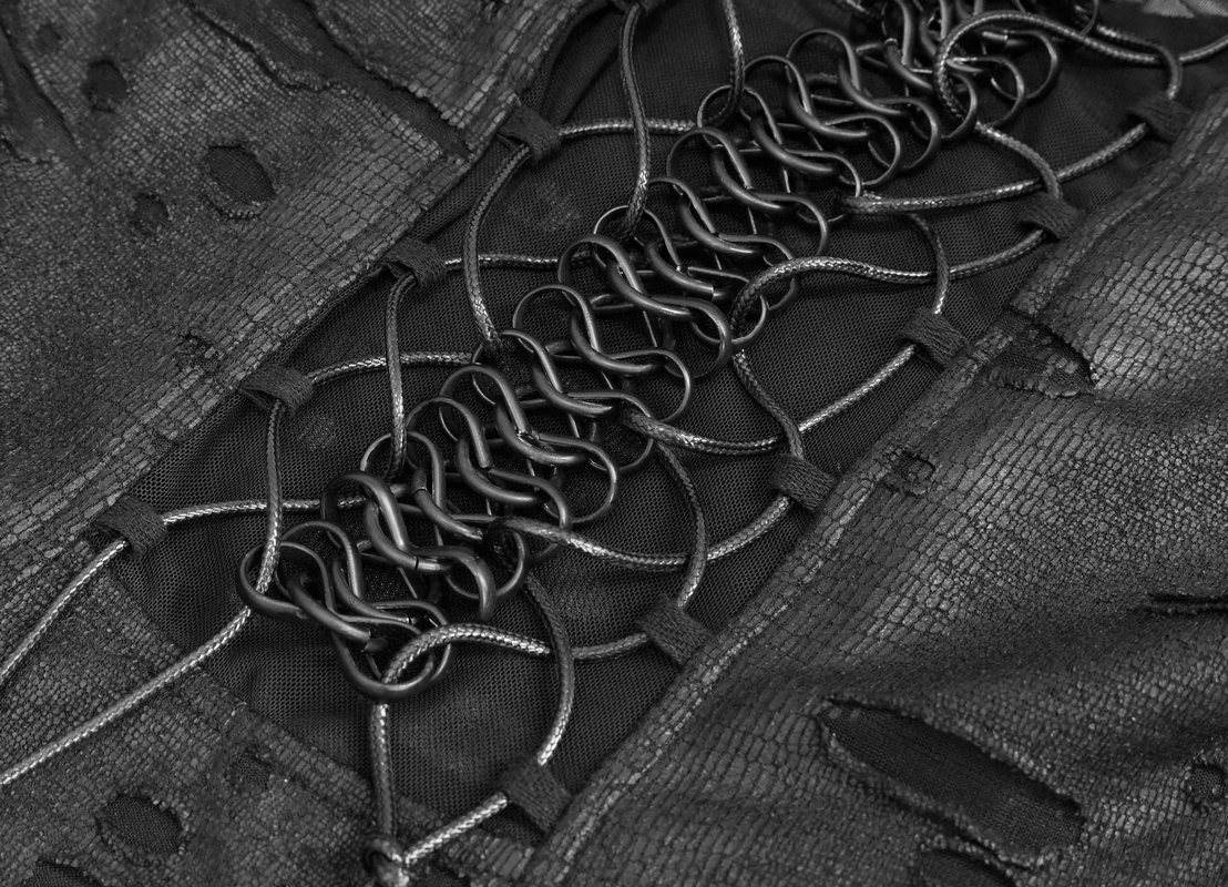 Close-up of intricate lace detailing and metal lacing on a black gothic dress, showcasing its edgy style.