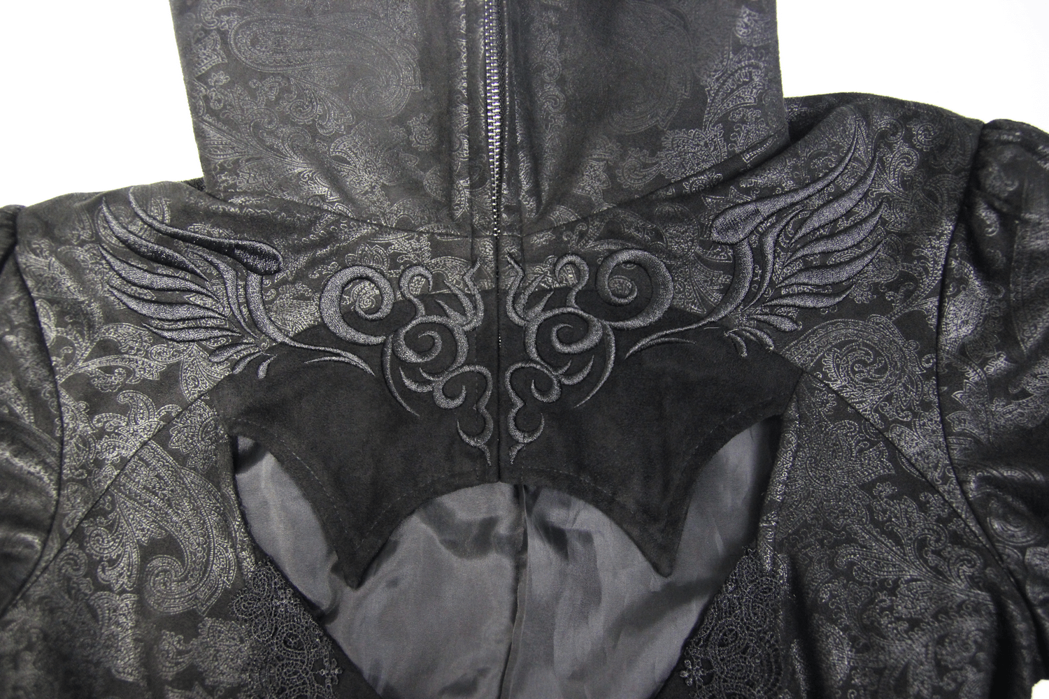Close-up of embossed detailing on a Gothic long coat, featuring intricate wing designs and a Victorian-inspired style.