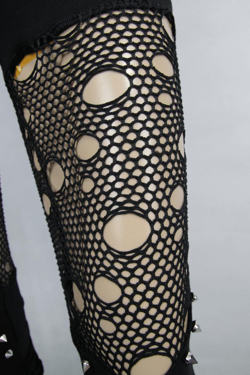 Close-up of black lace hollow-out mesh fabric showing unique circular cutouts for gothic flared pants.