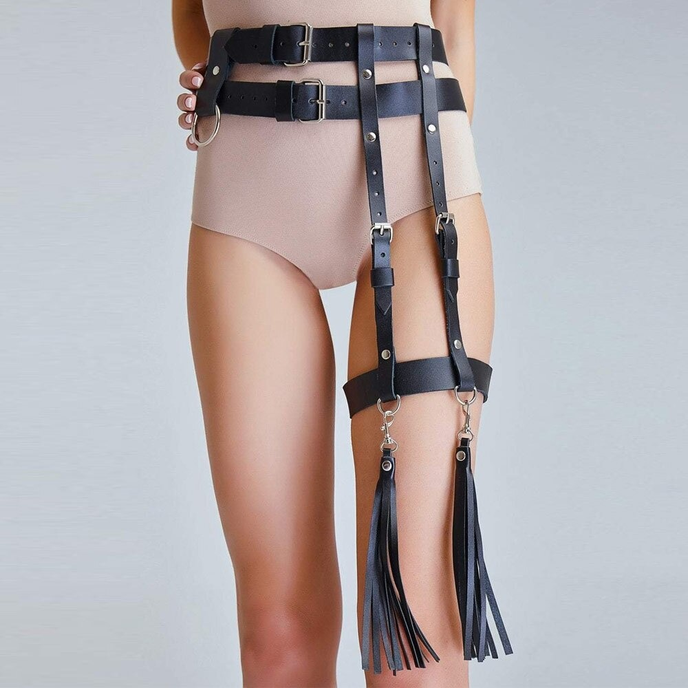 Black garter belt body harness for women featuring PU leather straps and stylish tassels, perfect for a rock-inspired look.