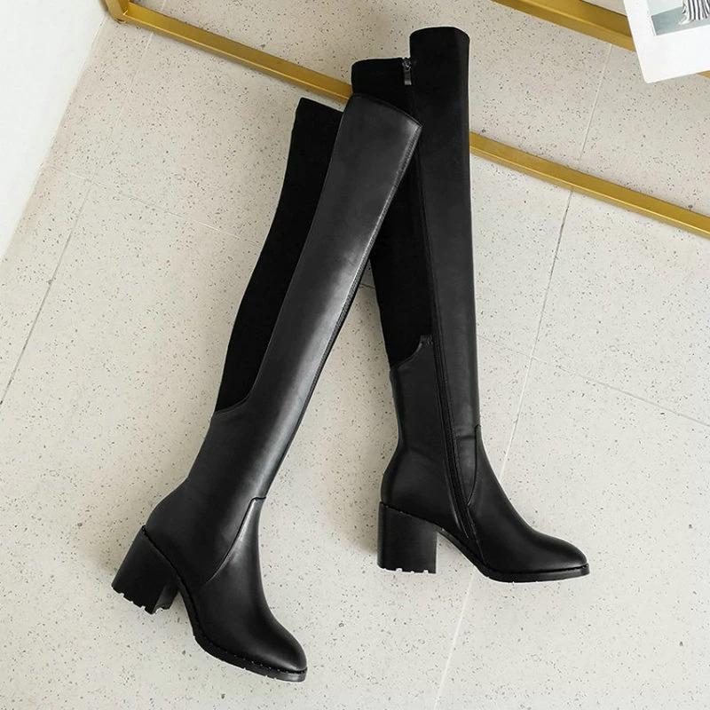 Stylish black knee-high women's boots in genuine leather with round toe and flat heel, perfect for casual elegant attire.