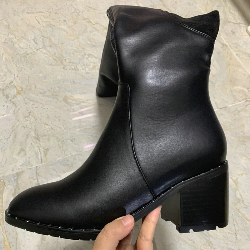 Stylish black genuine leather women's boots with round toe and block heel, perfect for casual elegance.