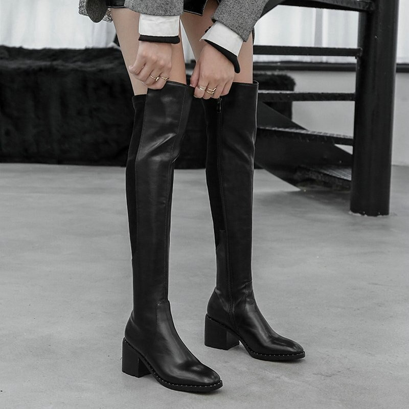 Stylish black genuine leather knee-high boots with round toe and chunky heel, perfect for casual elegance.