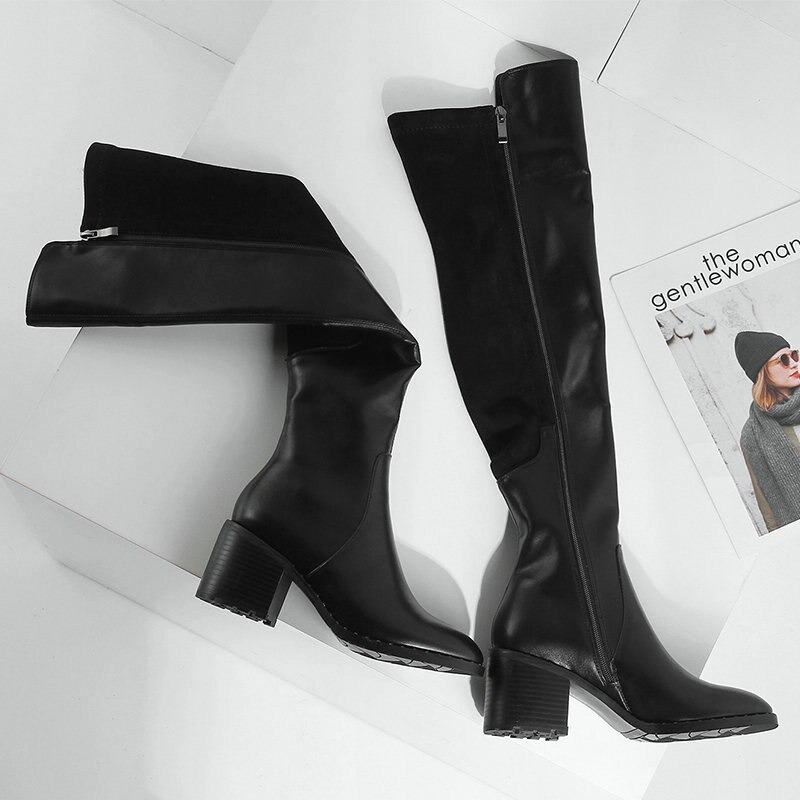 Stylish black genuine leather knee-high boots with a round toe and flat sole, perfect for casual elegance.