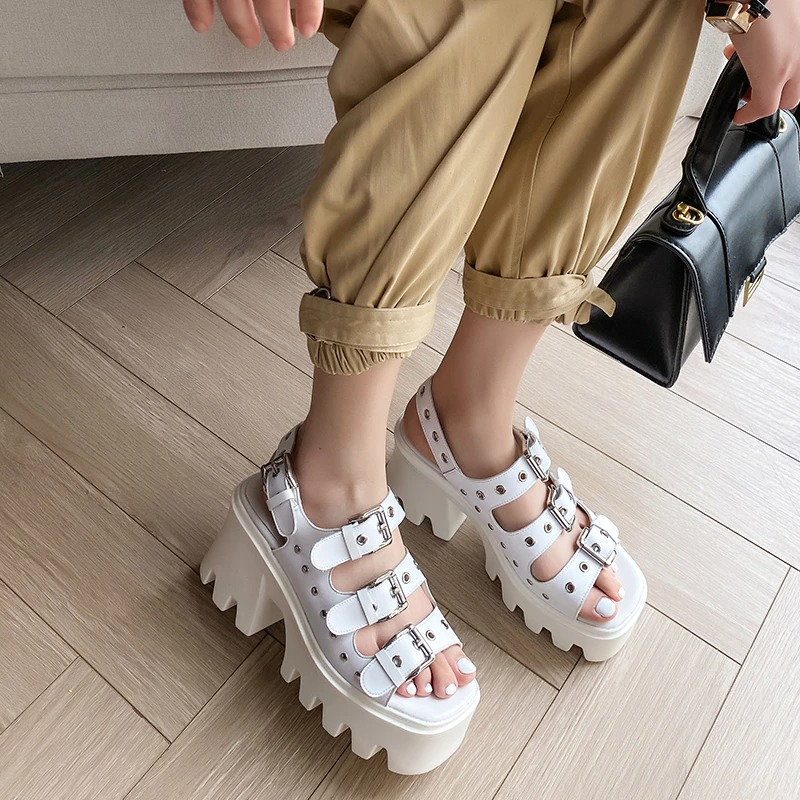 Stylish white platform sandals with buckles, perfect for punk-inspired summer outfits.
