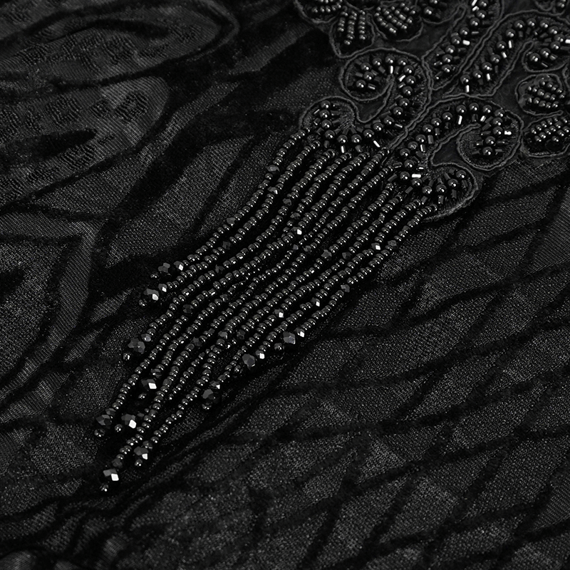 Close-up of exquisite black lace with tasseled beading detail, perfect for gothic fashion.