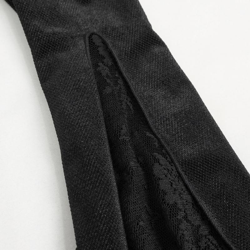 Close-up of black gothic lace detailing on women's long sleeve top, showcasing luxurious textile design.