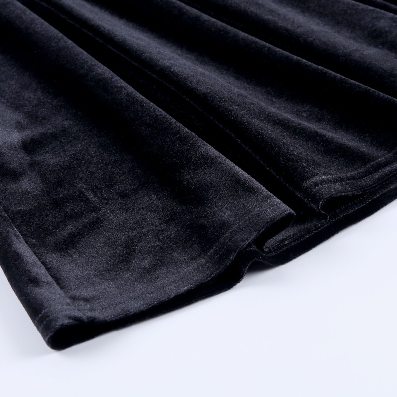 Close-up of soft black velvet fabric, showcasing the luxurious texture of the gothic mini dress.