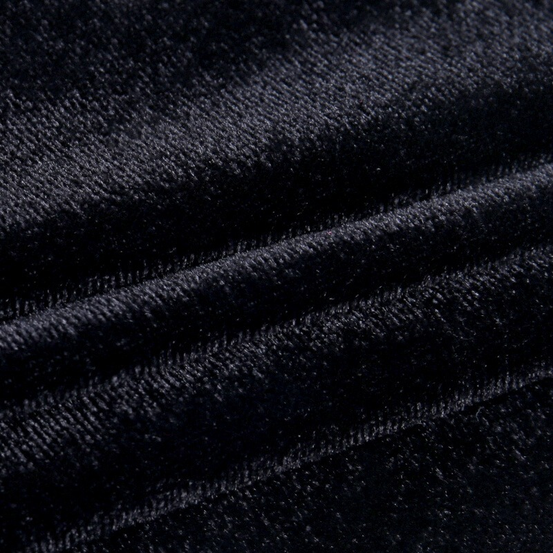 Close-up of luxurious black velvet fabric, perfect for a gothic mini dress with soft texture and elegant sheen.