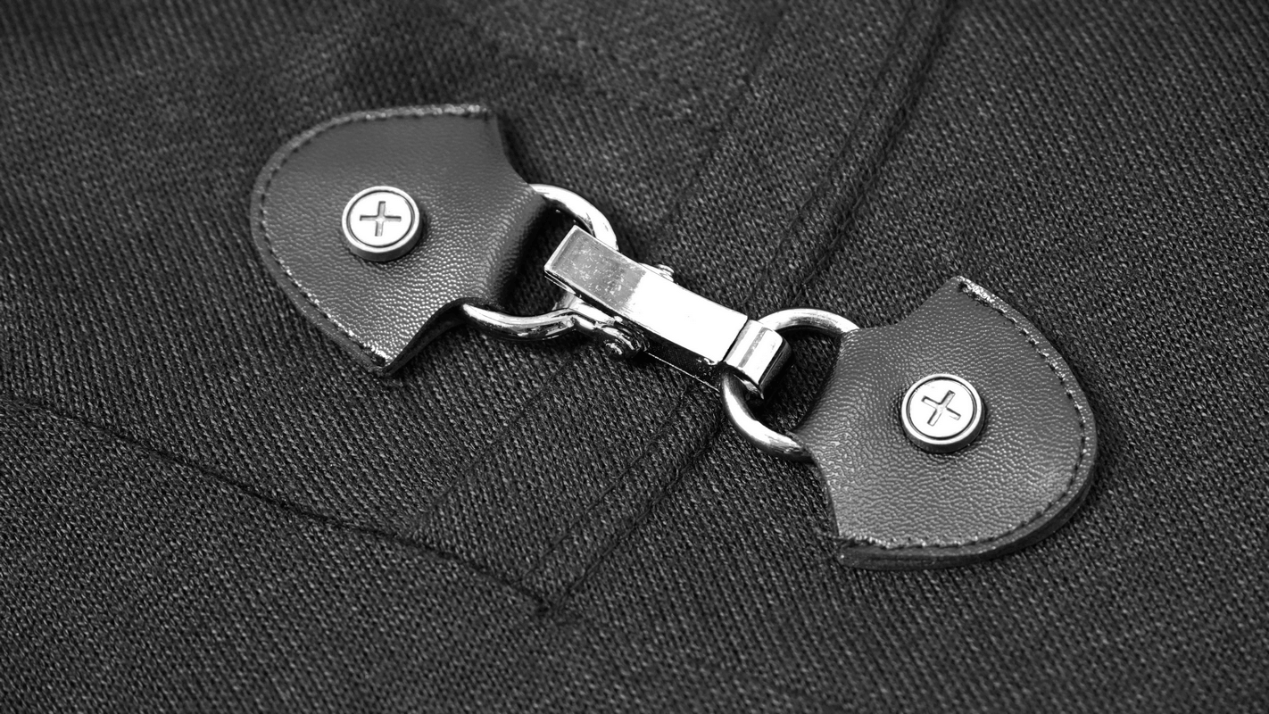 Close-up of a stylish buckle on a black Gothic punk hoodie, showcasing fashionable details.