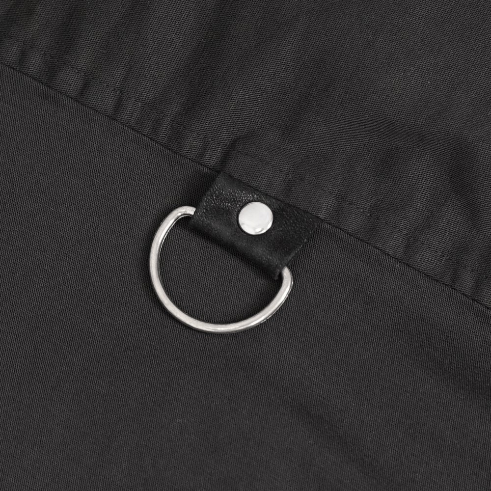 Close-up of black fabric with a silver metal ring and snap button detail for a gothic punk shirt.
