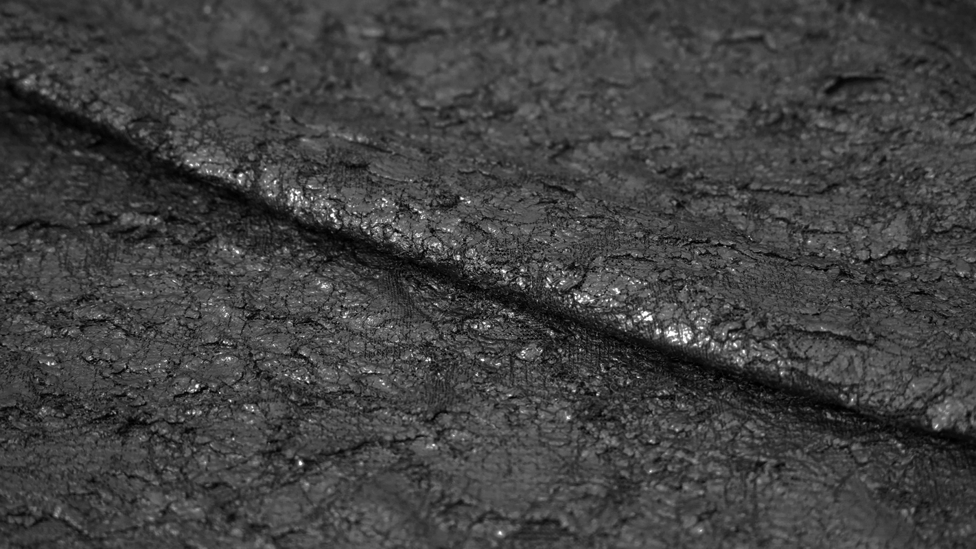 Close-up of textured black fabric, perfect for gothic style fashion and trendy men's apparel.