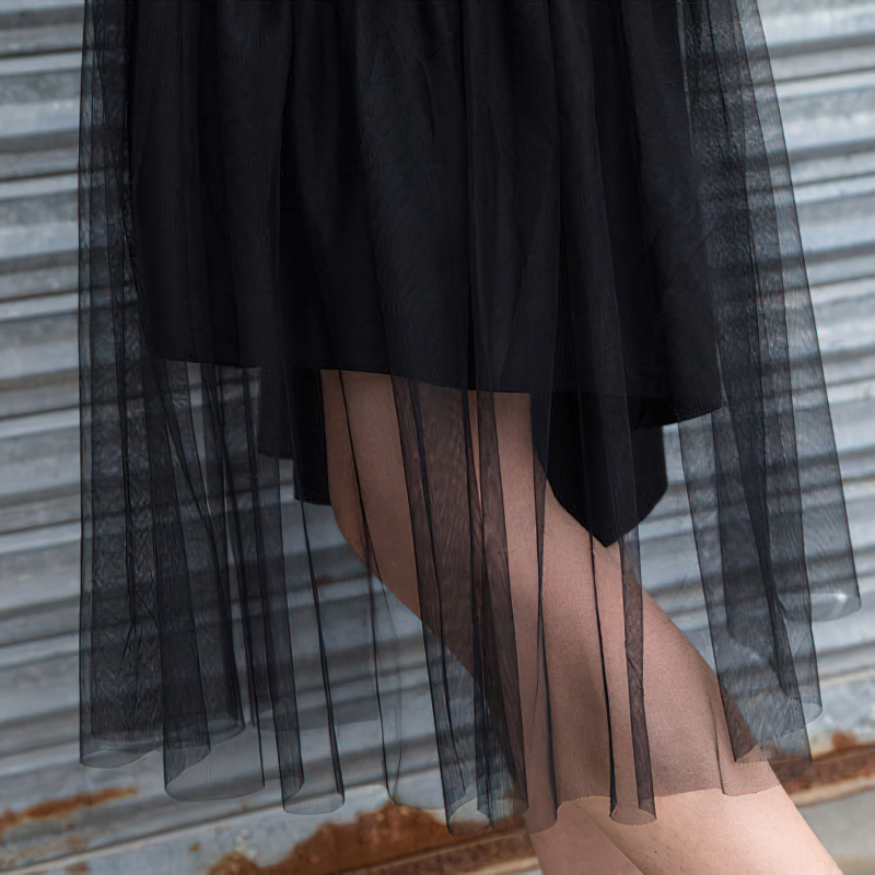Close-up of a stylish black mesh skirt with layered frills, perfect for alternative outfits.