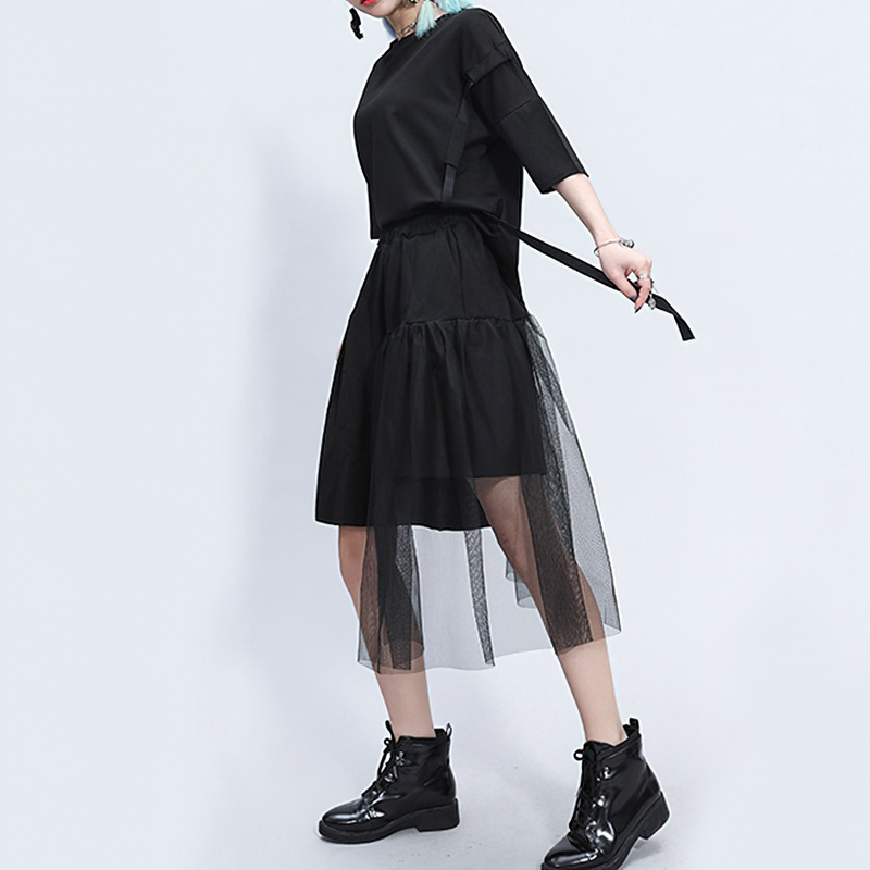 Black irregular half-length trousers with mesh detailing, perfect for alternative fashion and rockstar styles.