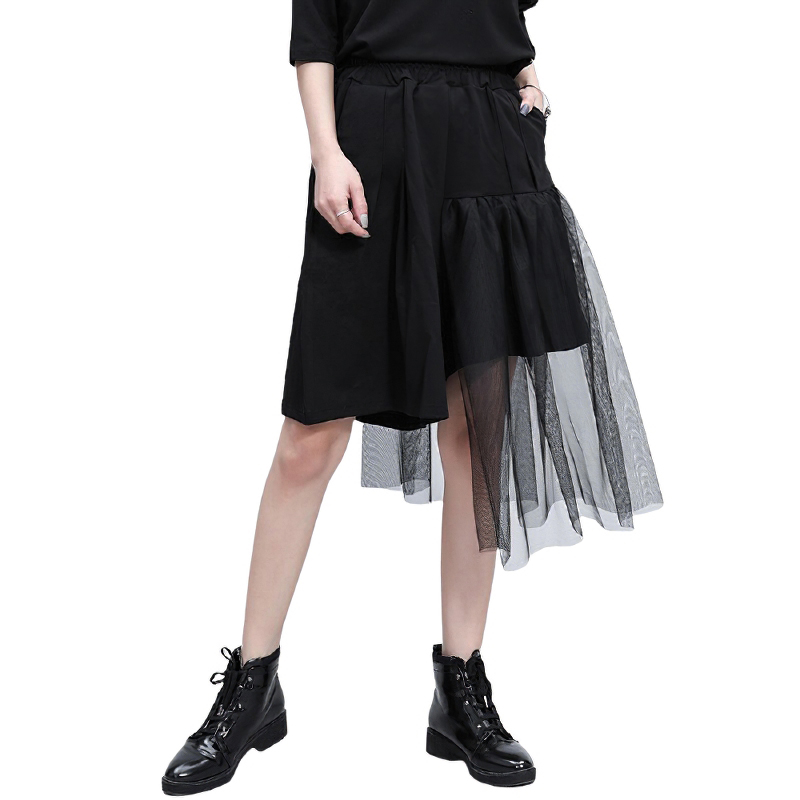 Black asymmetrical half-length trousers with mesh layer and high elastic waist, perfect for alternative fashion.