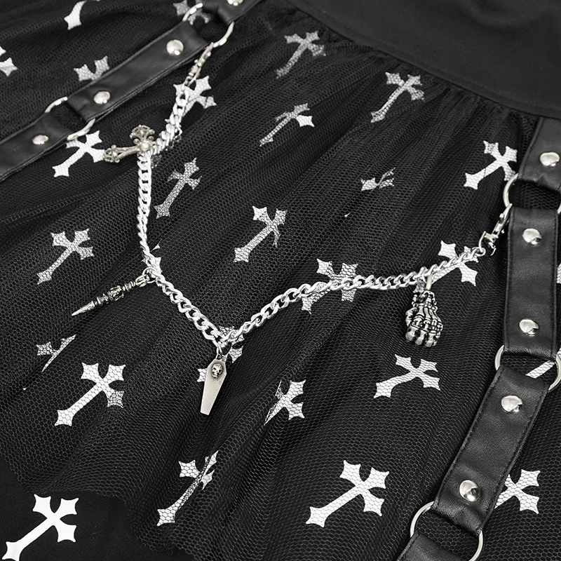 Close-up of black knitted skirt featuring white crosses print and decorative silver chain embellishments.