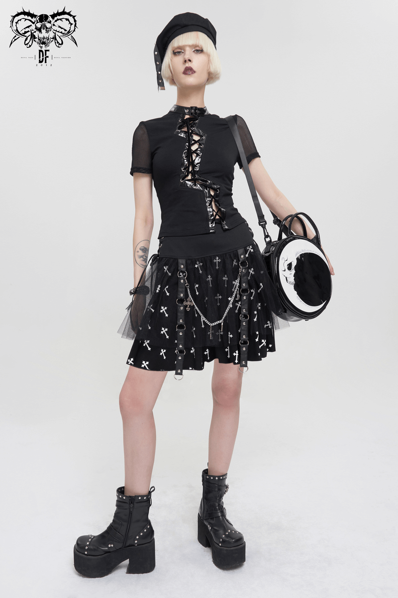 Punk women wearing a black knitted skirt with white crosses print, styled with edgy accessories and chunky boots.