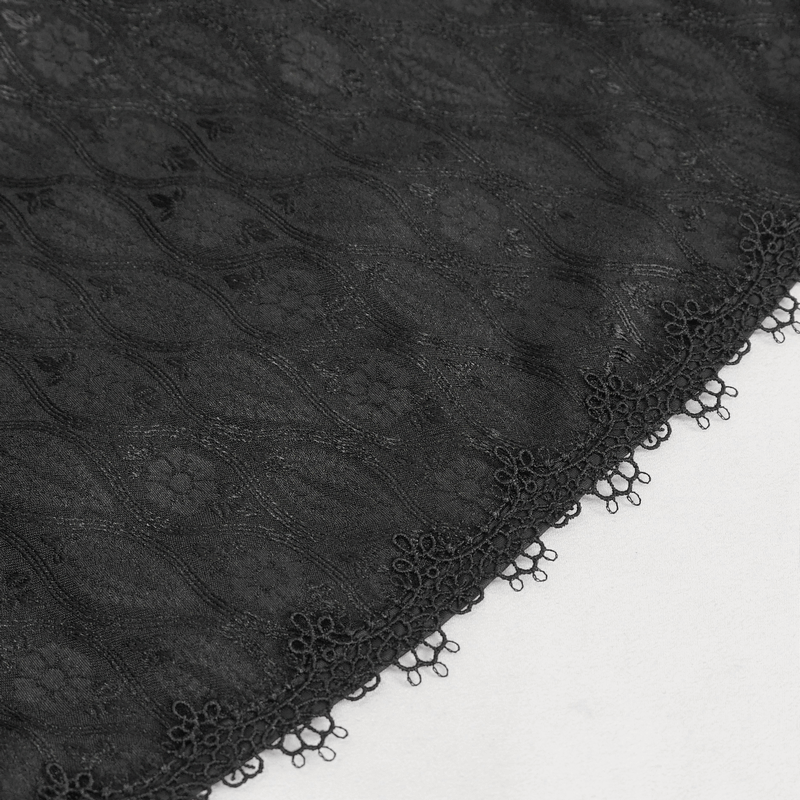 Close-up of elegant black lace fabric with intricate patterns and delicate scalloped edges.