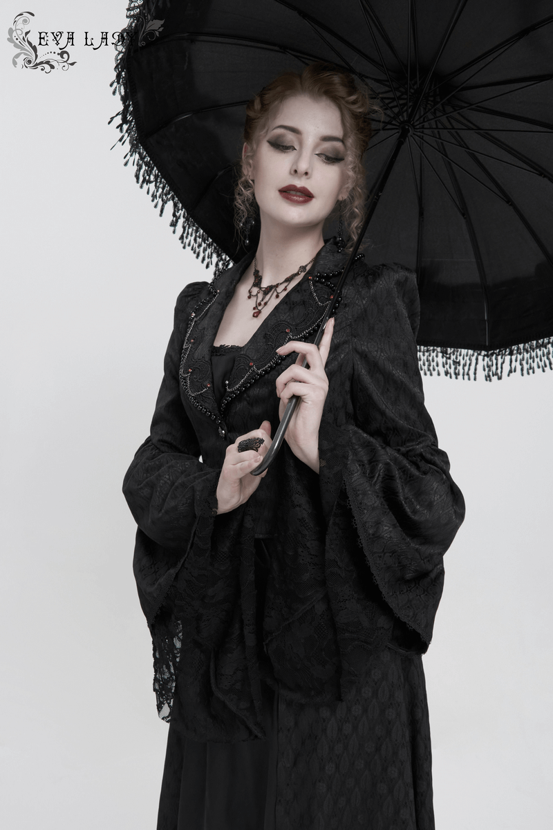 Elegant woman in black flared sleeves beaded long coat with parasol, showcasing gothic retro fashion.