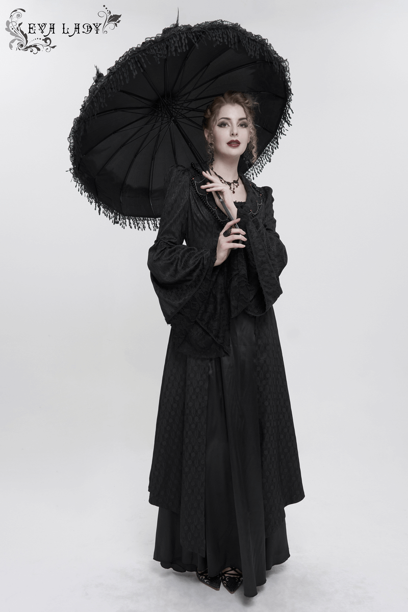 Elegant model in a black gothic long coat with flared sleeves and parasol, showcasing retro style.