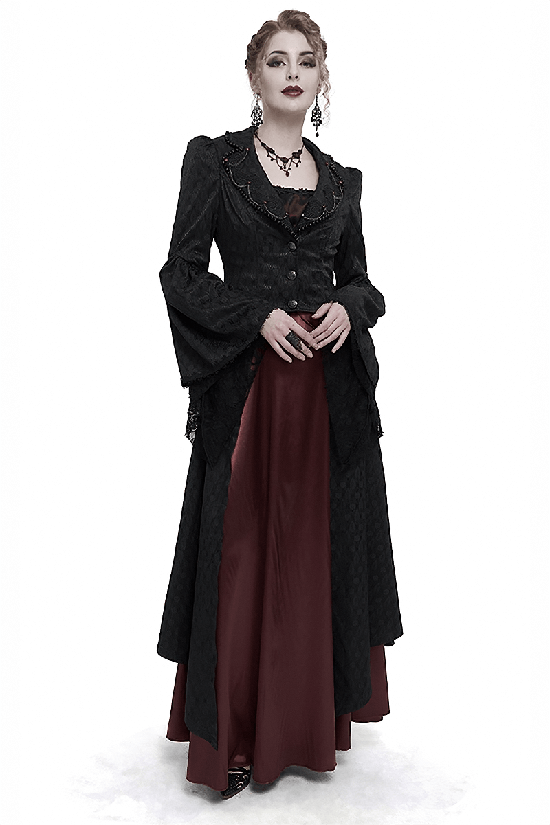 Elegant woman in a black flared sleeves beaded long coat with a vintage gothic style, showcasing dark beauty and sophistication.