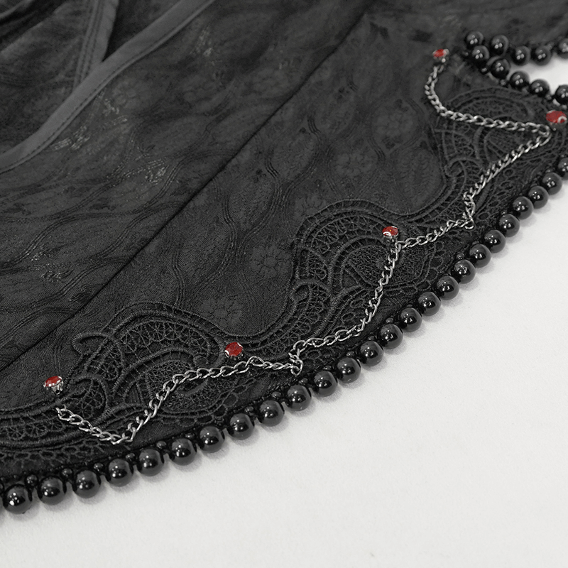 Close-up of elegant black lace and beaded detailing on a gothic long coat with flared sleeves.