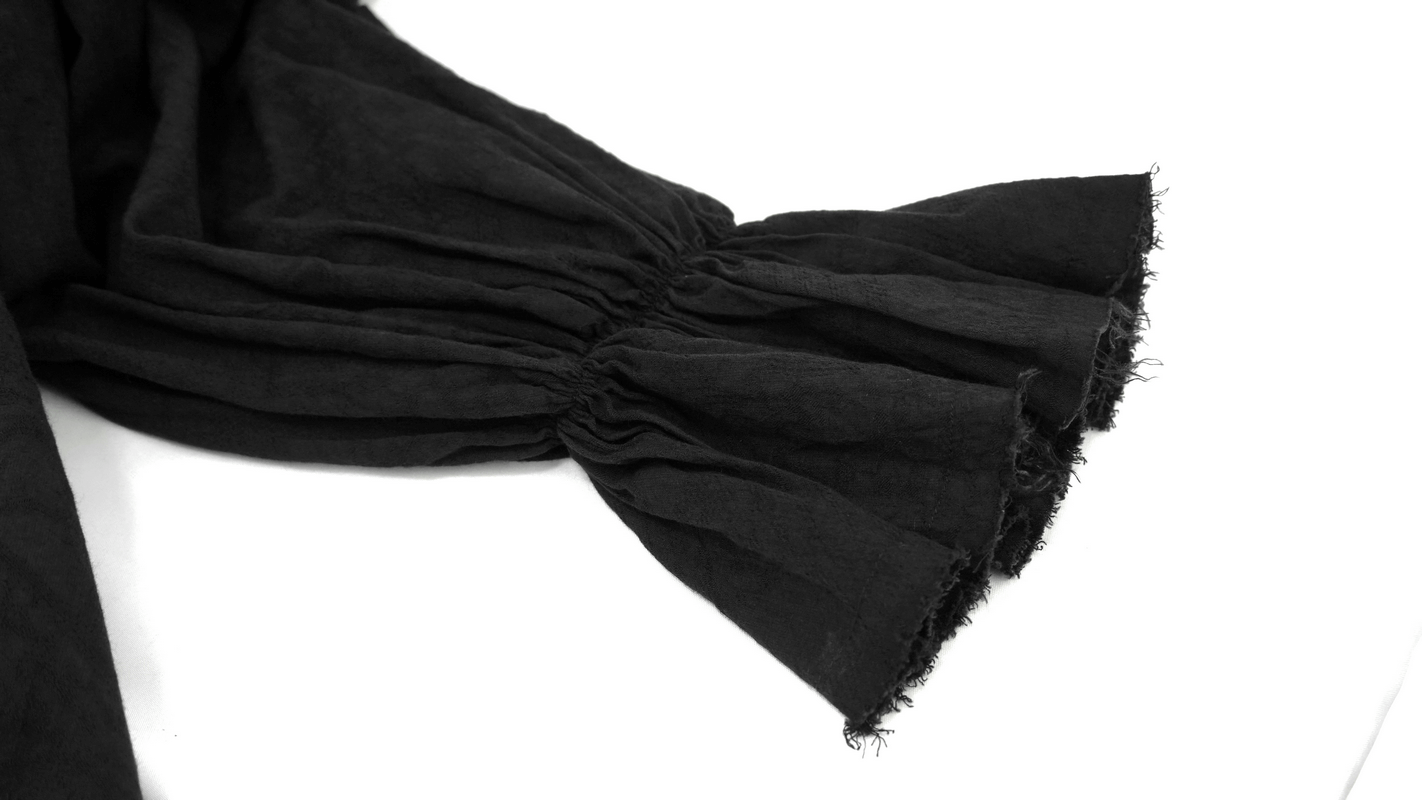 Close-up of the flared cuff of a black gothic style men's shirt, showcasing vintage fabric texture and style.