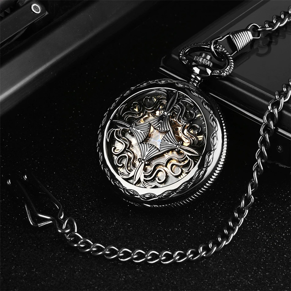 Antique black mechanical pocket watch with intricate design and chain, featuring Roman numerals for vintage style.
