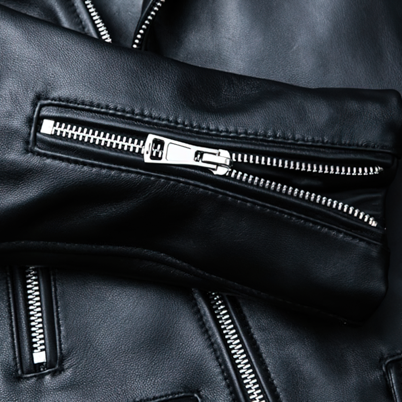 Close-up of a black leather jacket sleeve featuring a stylish zipper and high-quality genuine leather.