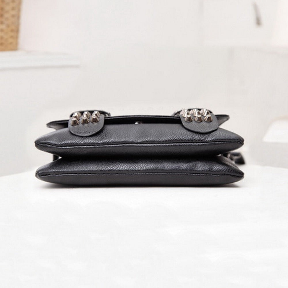 Stylish black messenger bag with skulls and rivets, featuring a sleek design for alternative women's fashion.