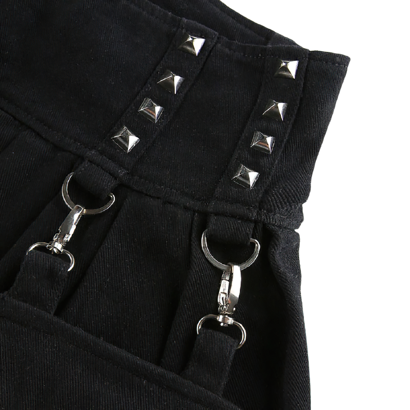 Close-up of black patchwork skirt pants with silver rivets and clip fasteners, showcasing gothic fashion details.