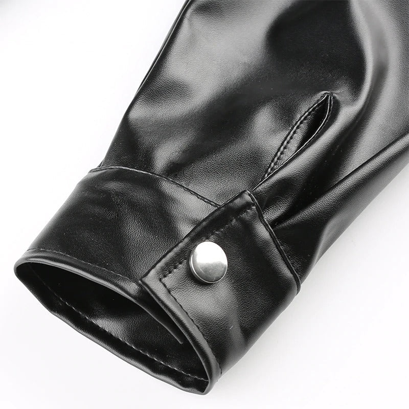 Close-up of the cuff of a black PU leather blouse showcasing stylish button detail and sleek finish.