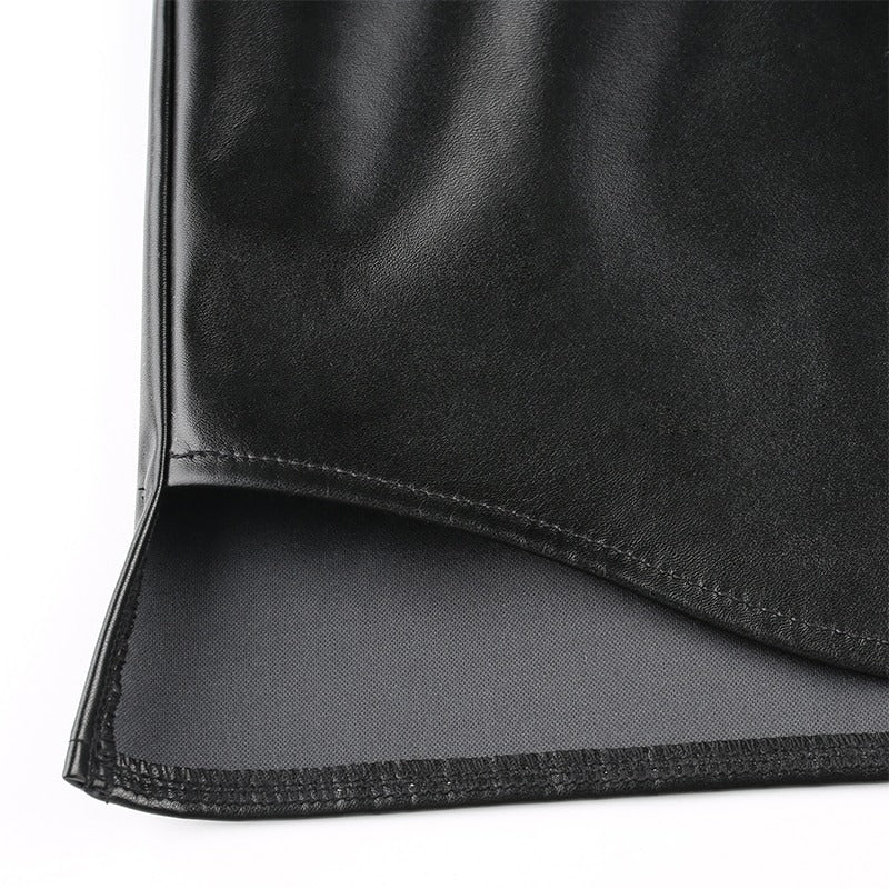 Close-up of the hem of a black PU leather blouse with smooth texture, showcasing stylish detailing and quality material.