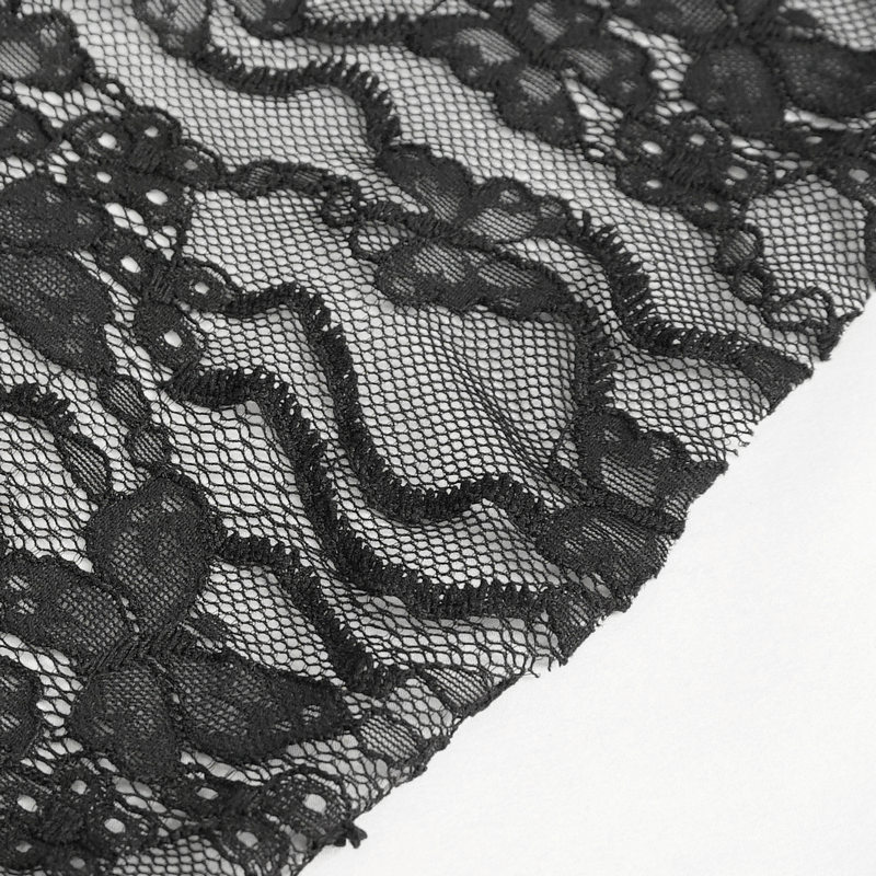 Close-up of black lace fabric with floral patterns, perfect for gothic-style clothing and elegant designs.