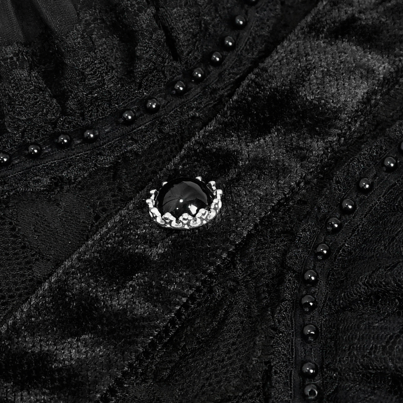Close-up of elegant black velvet fabric with lace detailing and decorative button for gothic blouse.