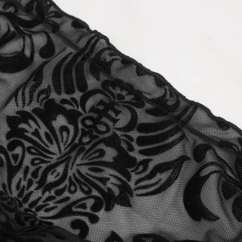Close-up of black velvet fabric with ornate floral pattern, showcasing vintage elegance for women's fashion.