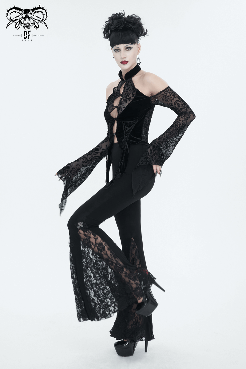 Model showcasing a black vintage velvet top with open shoulders, long lace sleeves, and chic black pants for a stylish look.