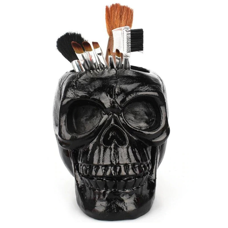 Black skull desktop pen holder with brushes, perfect for Halloween decor and office storage.