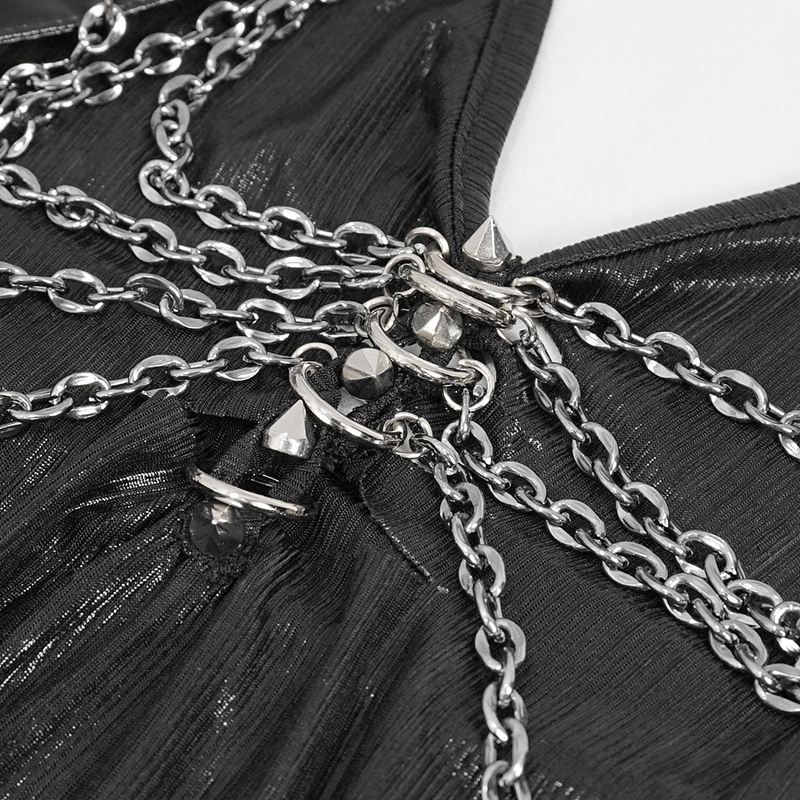 Close-up of chains and studs on a gothic black dress, highlighting edgy fashion details for women's clothing.