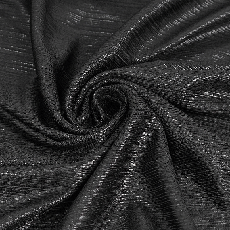 Close-up of smooth black fabric, showcasing the shiny texture ideal for gothic clothing designs.