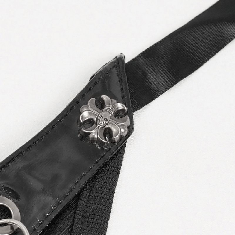 Close-up of black fabric strap with silver skull design, perfect for gothic fashion accessories.